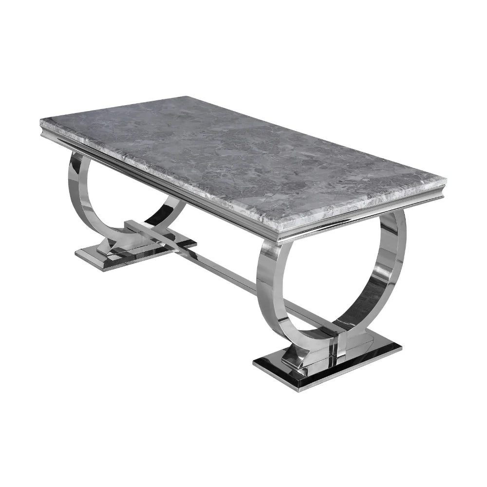 Dining table with marble top and chrome base on a white background