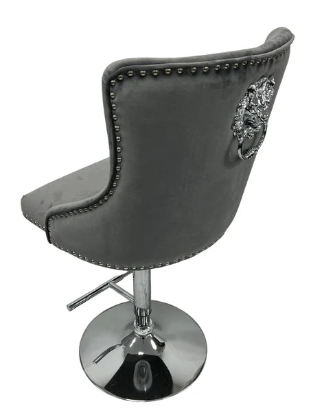 Grey chair with chrome base and knocker back design