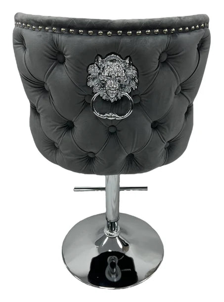 Grey tufted bar stool with lion emblem and chrome base first class interiors