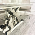 marble Dining table with modern, reflective metal legs in a room with chairs. first class interiors